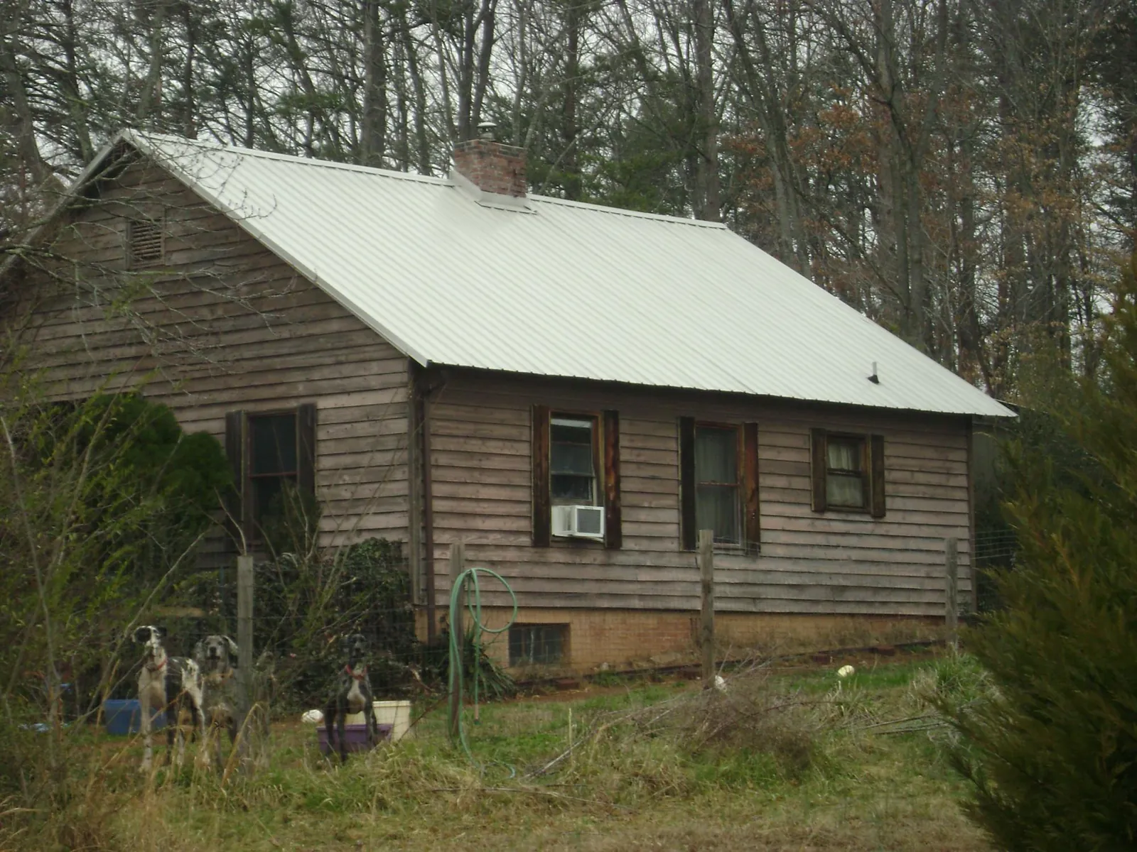 White metal roof on an old wood sided farmhouse, from a Metal Roof Installation job in Bridgewater